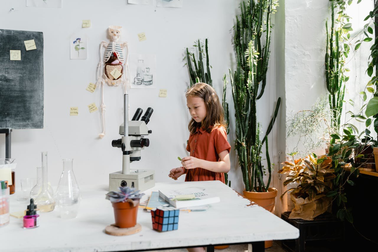 A young girl conducts an experiment in a classroom filled with plants and scientific tools.